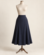 AI concept illustration of 1930s gored flared skirt, front view in ink navy, on a mannequin.