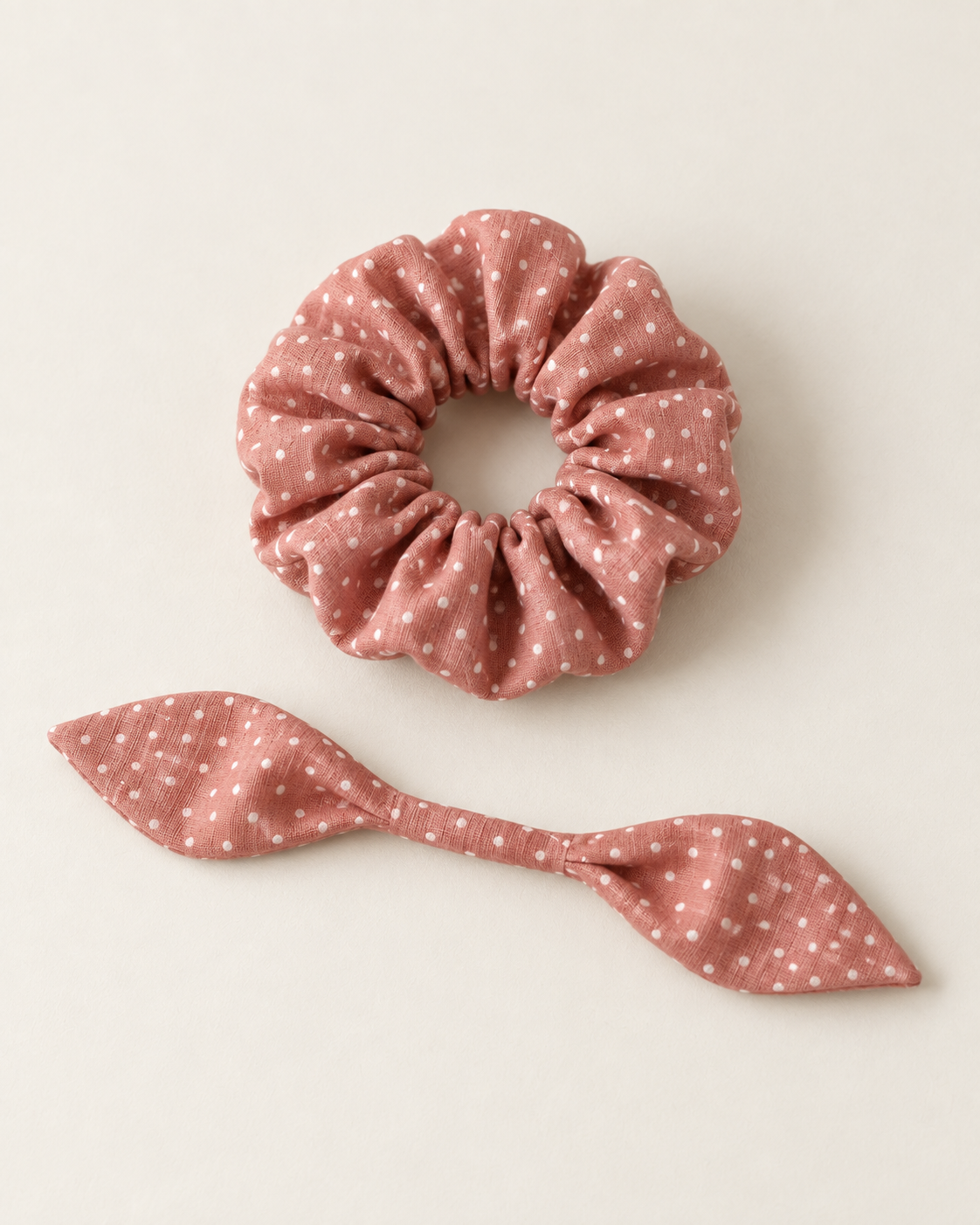 Design preview: matching gathered elastic scrunchie ring and its separate unknotted short tapered fabric tie on a plain surface