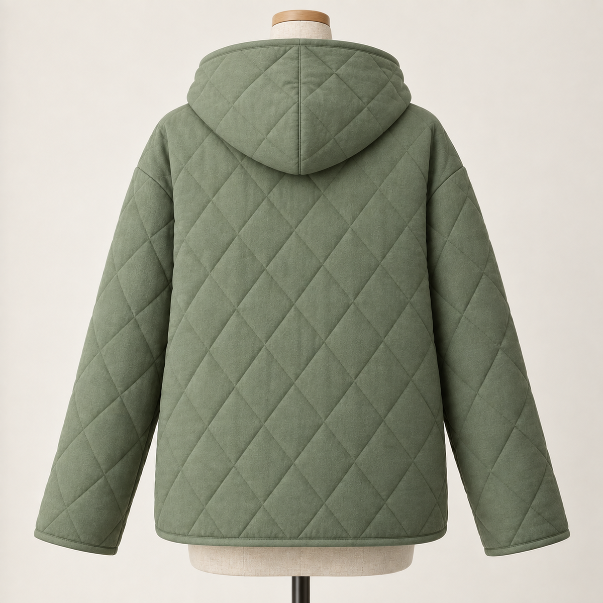 AI design preview: sage quilted jacket back with lowered center-seam hood, uninterrupted diamond-quilted body and long loose sleeves