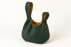 AI design preview: open green Japanese knot bag from the rear with unequal closed loop handles and ochre lining
