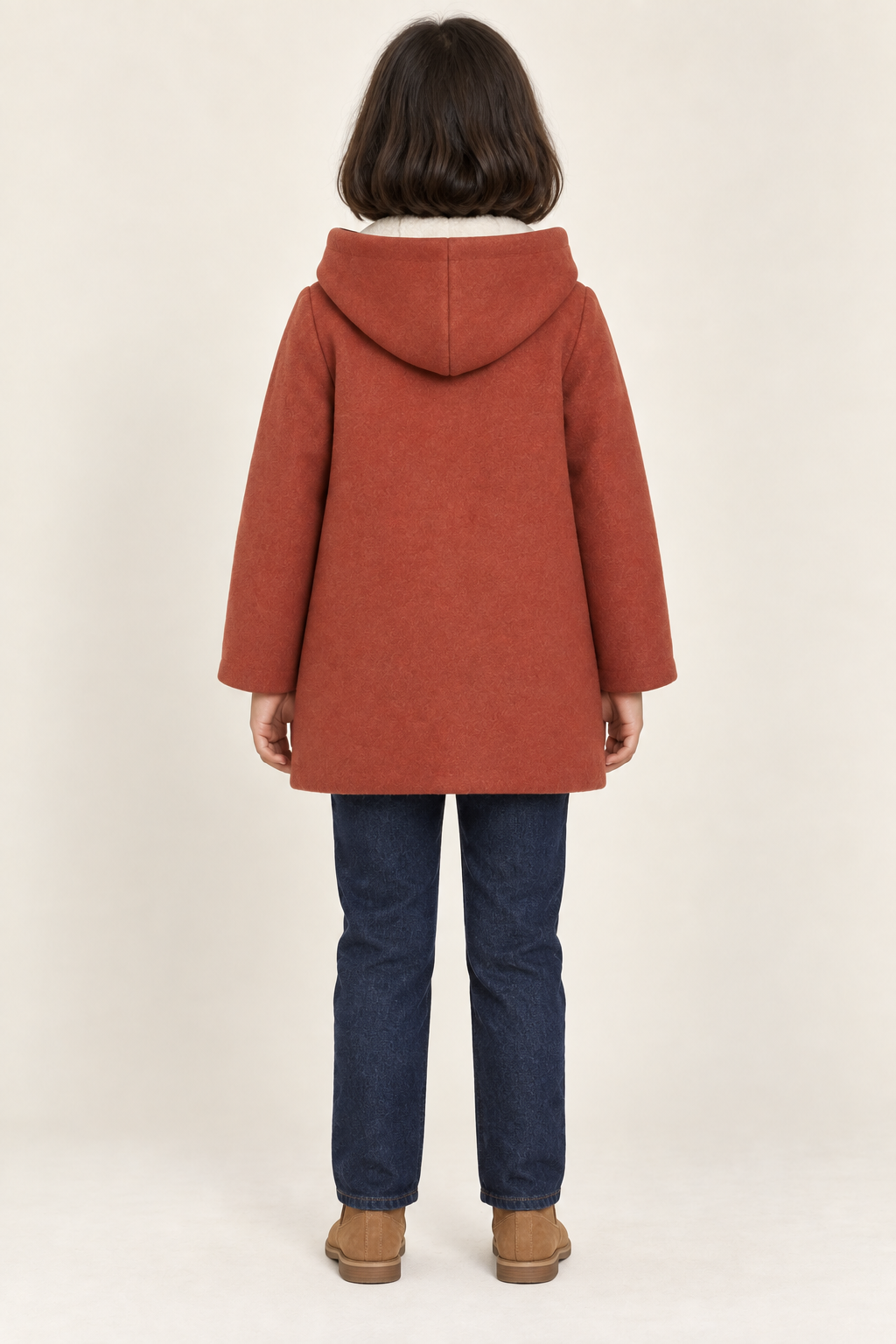 AI design preview: same child in a terracotta hooded coat showing plain gently flared back and center-seamed hood, rear view
