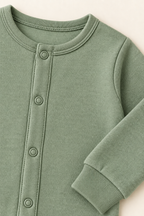 AI concept detail of the coverall rib neckline, tonal snap band and wrist cuff