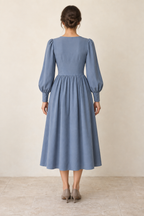 AI design preview: rear of the same dusty-blue dress, showing a closed darted bodice, one waist seam and gathered midi skirt