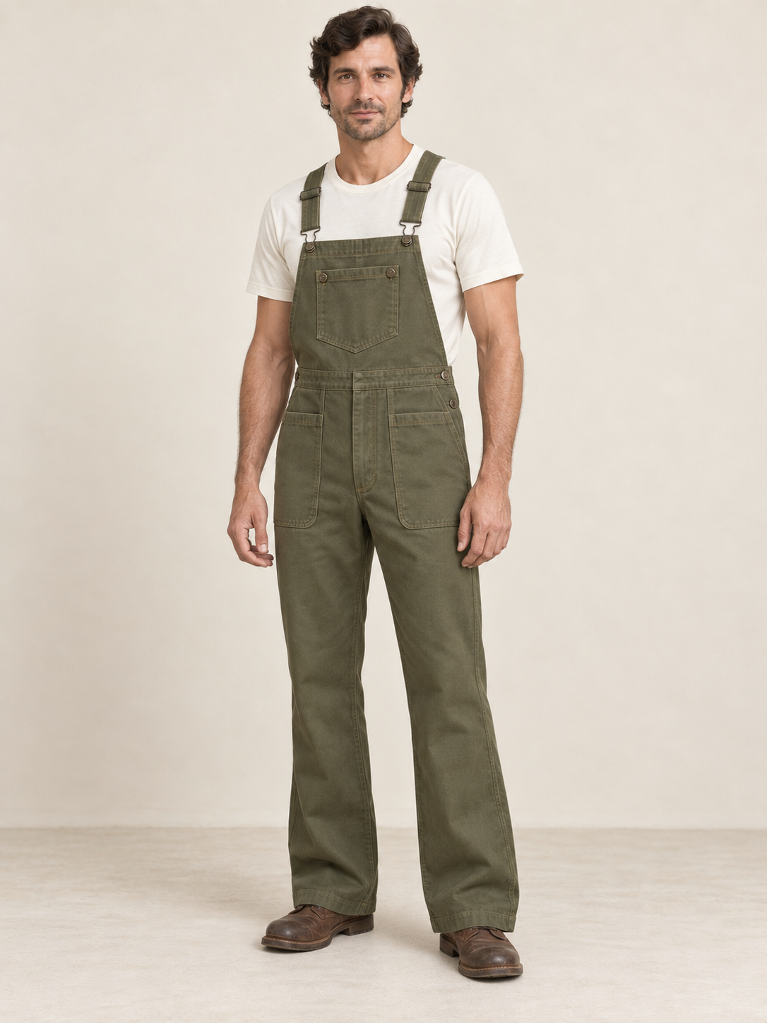 Man wearing coordinated olive bib overalls with angular bib pocket and side-button openings