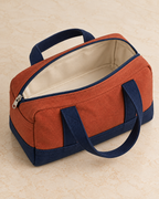 Design preview: same mini duffel unzipped to show one empty cream-lined compartment and a single zipper slider