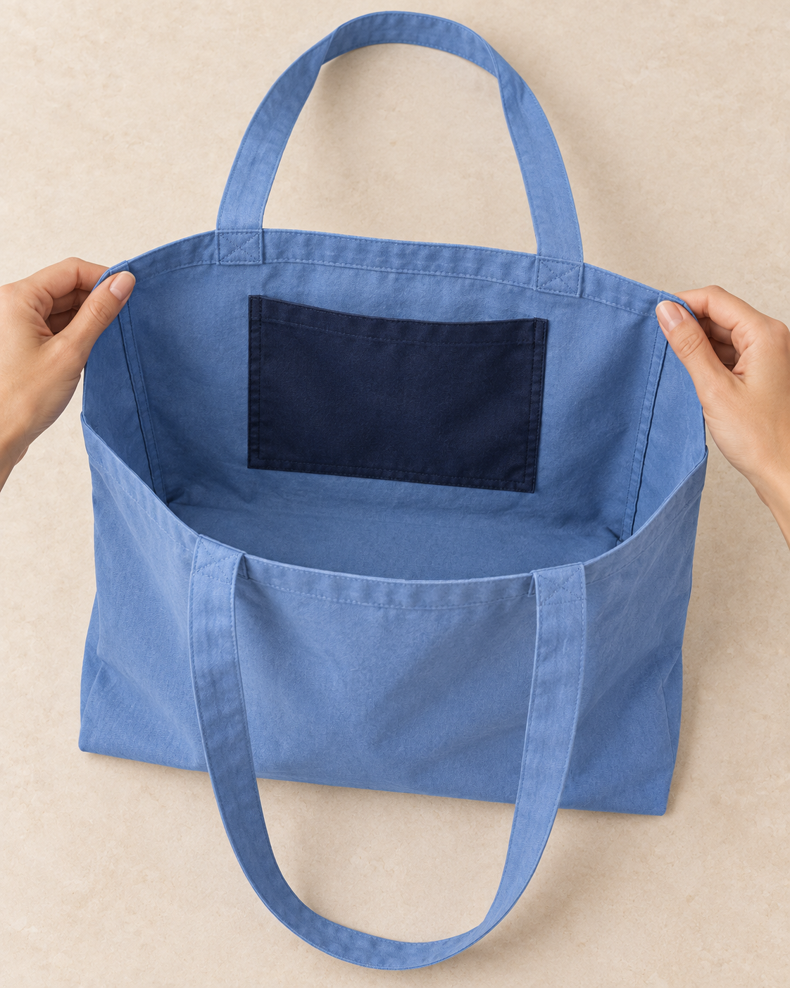 Design preview: inside of the same unlined blue tote showing the fixed navy storage pocket sewn at its sides and bottom