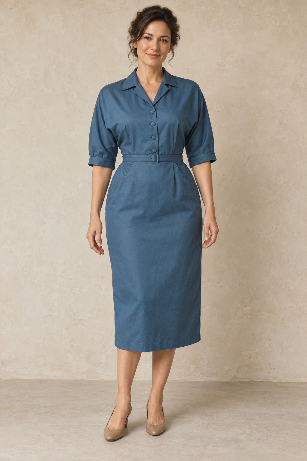 Peacock-blue dolman shirt dress design preview on an adult woman, front view showing the pointed collar, four bodice buttons and curved inset skirt pockets.