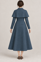 AI design preview: back of petrol princess coat with curved shoulder cape, shaped vertical panels and closed flared hem
