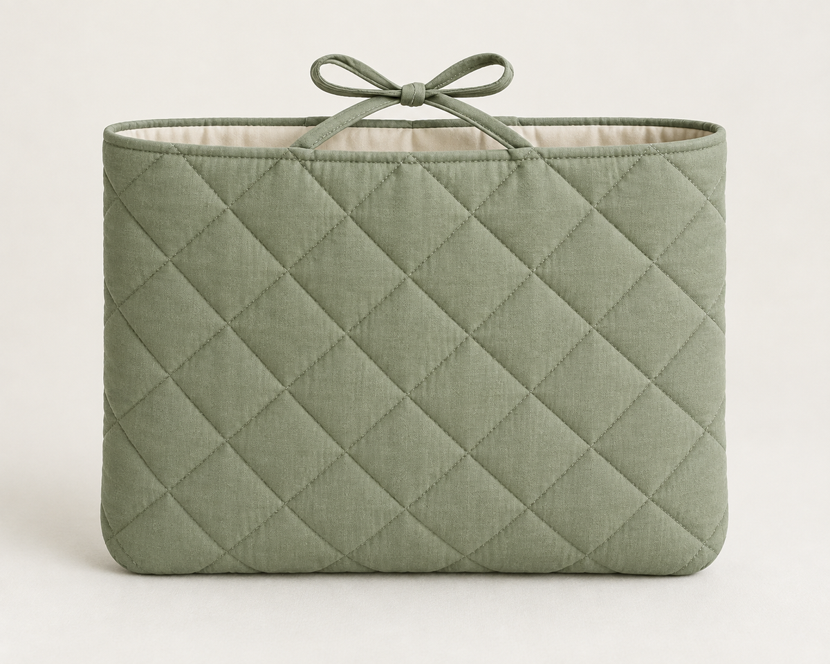 AI design preview: sage quilted book sleeve with rounded lower corners and a top-center fabric bow