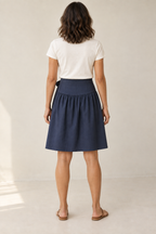 Rear design preview of the navy face of the reversible skirt, showing the smooth contoured yoke and one gathered lower section