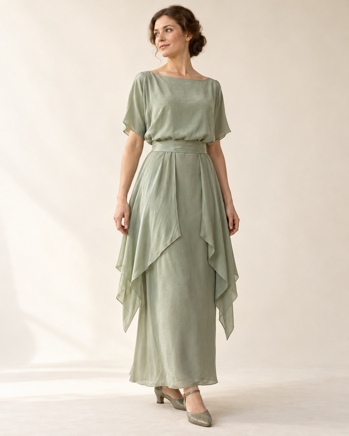 AI design illustration of a celadon 1910s draped-hip dress with a broad waist sash and pointed side layers, front view
