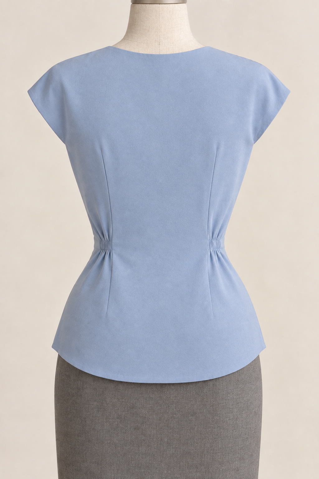 AI design preview: powder-blue blouse back with a high round neckline, waist darts, cut-on cap sleeves and curved hem.