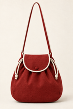 AI front preview of the same rounded drawstring shoulder bag in brick red with ivory edging