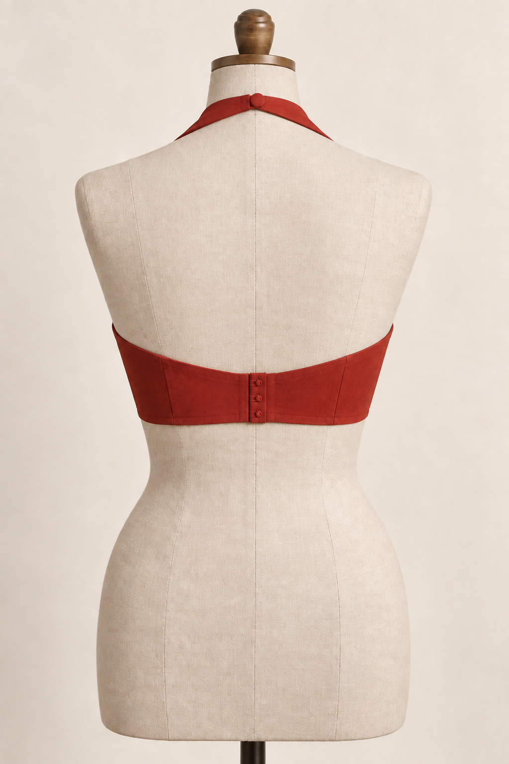 AI back preview of the brick-red halter bra with a covered neck button, open upper back and three-button fabric back closure