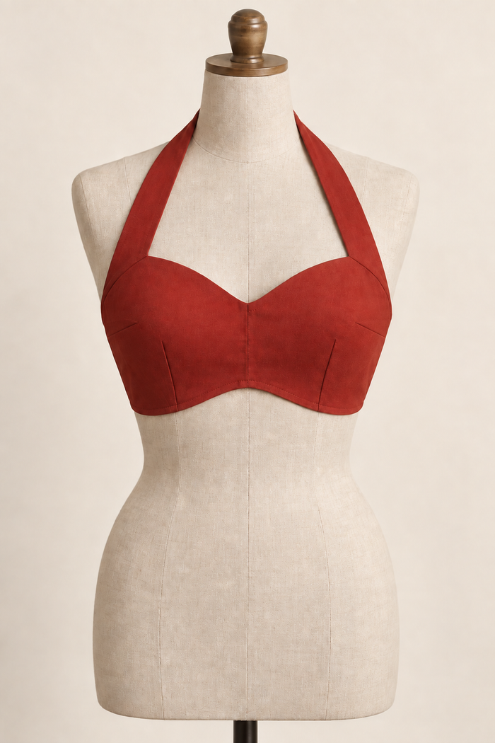 AI front preview of a brick-red woven halter beach bra with broad neck straps, bust darts and a centre-raised curved hem