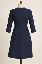 AI design preview: solid-navy dress back with shaping darts, center-back zipper and three-quarter sleeves.