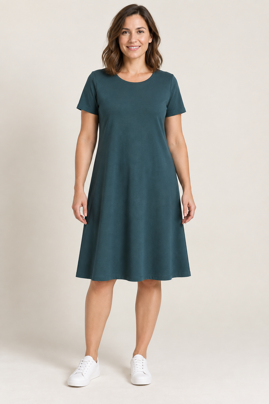 Design preview of a teal A-line knit day dress with a rounded banded neckline, front view.