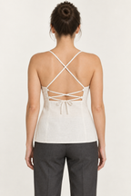AI preview: cream camisole rear with crossed shoulder straps, narrow upper-back lacing and a closed lower-back panel.