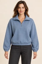 AI preview: dusty-blue half-zip knit pullover with a folded collar, dropped shoulders and gathered elastic hems.