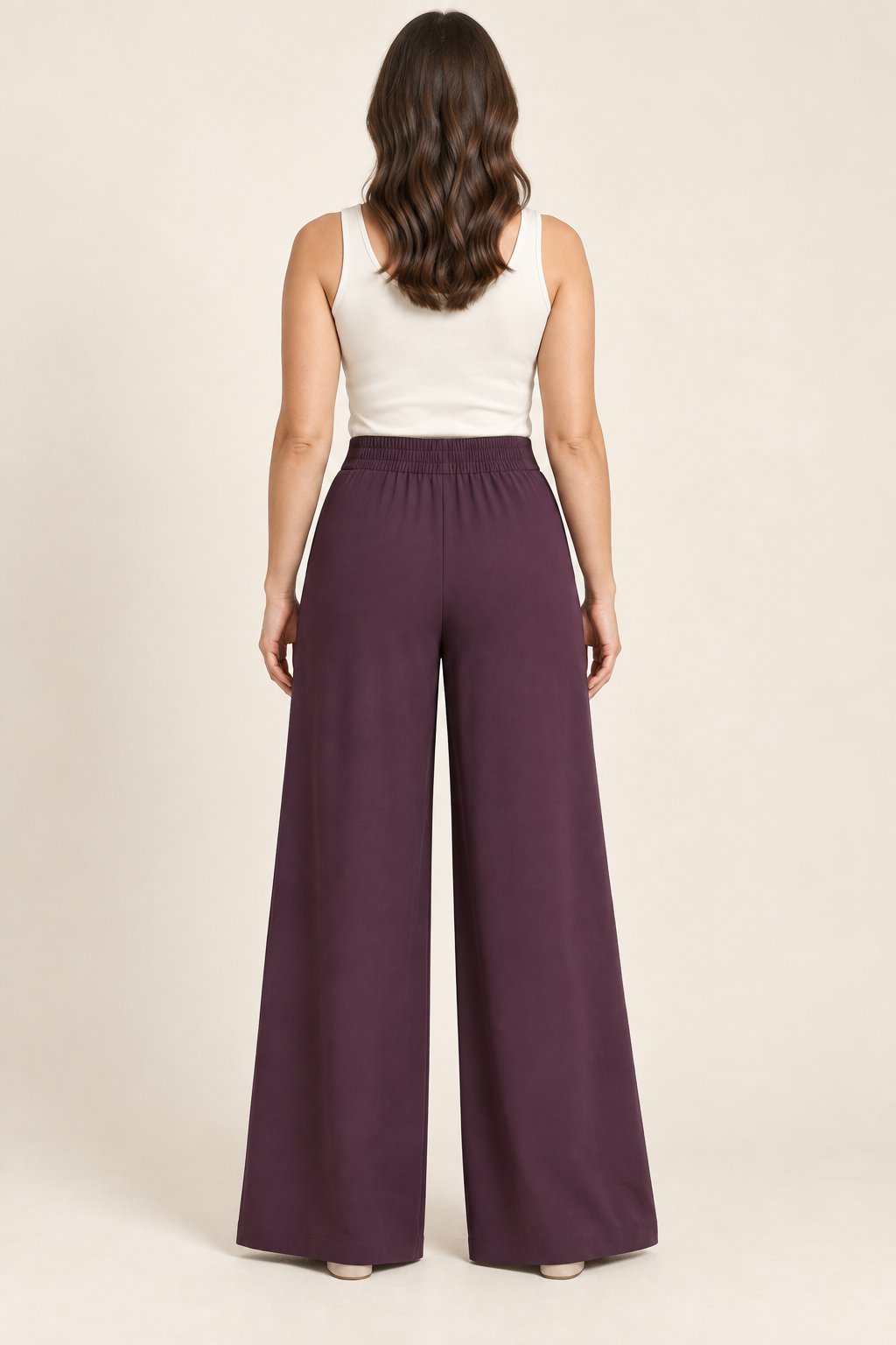 AI preview: back of aubergine palazzo pants showing rear-only elastic waistband and plain wide legs.
