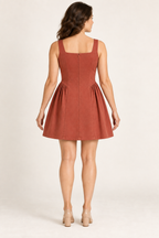 AI preview: rear of brick panel mini dress with a concealed back zipper, continuous center panel and gathered side inserts.