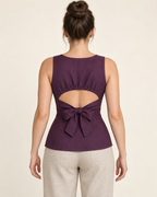AI design preview: aubergine top back with high round neckline, gathered upper-panel edge, mid-back cutout and broad waist bow