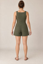 AI design preview: olive romper rear with a high shallow-square neckline, concealed center-back zipper, shaping darts and plain short legs