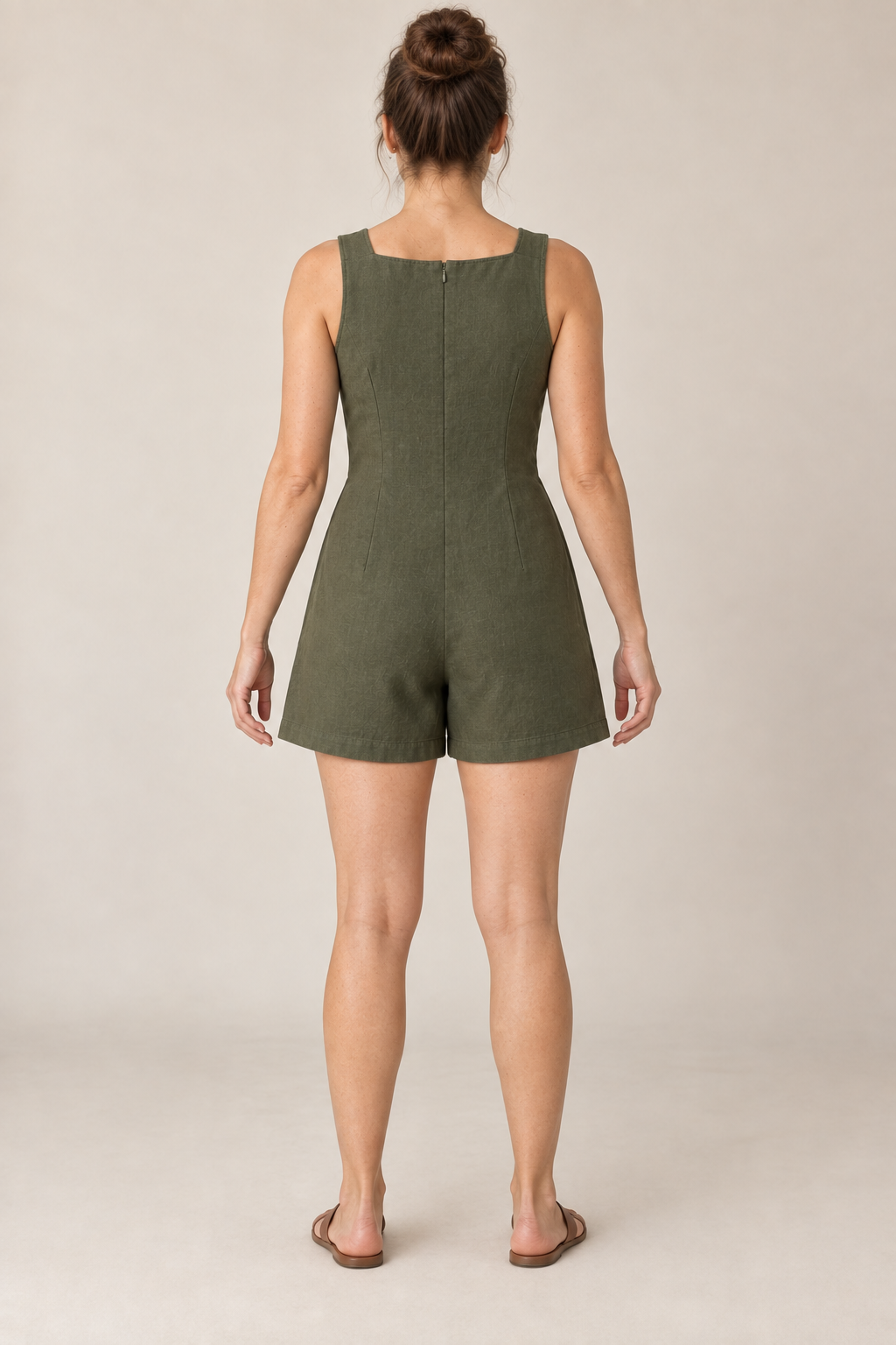AI design preview: olive romper rear with a high shallow-square neckline, concealed center-back zipper, shaping darts and plain short legs