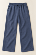 AI preview: men's dusty indigo linen trousers with a full elastic drawcord waist, diagonal inset pockets and straight wide legs.