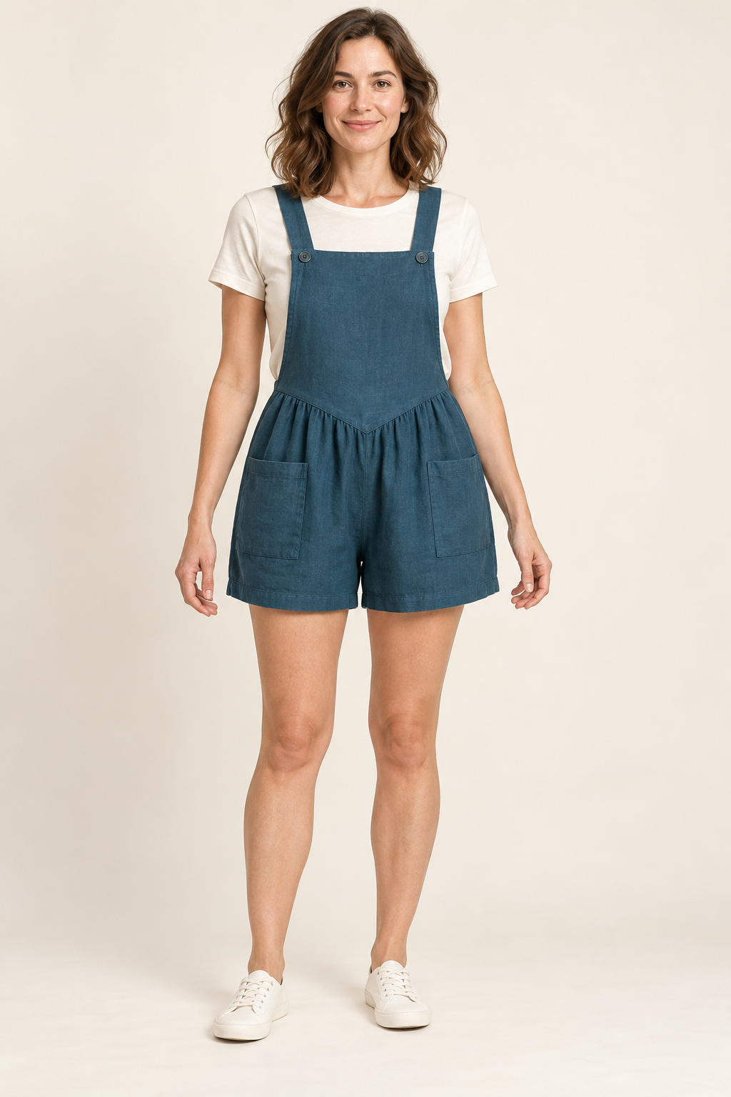 AI design preview: petrol short overalls with a smooth pointed front bib, two strap buttons, gathered shorts and two front patch pockets