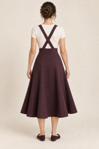 AI design preview: aubergine skirt rear with crossed buttoned suspenders, straight raised upper edge and continuous shaped gore seams