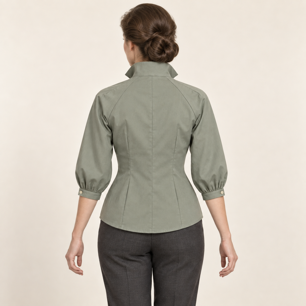 AI design preview: sage blouse rear showing raglan seams, a closed high collar, center-back seam and paired waist darts