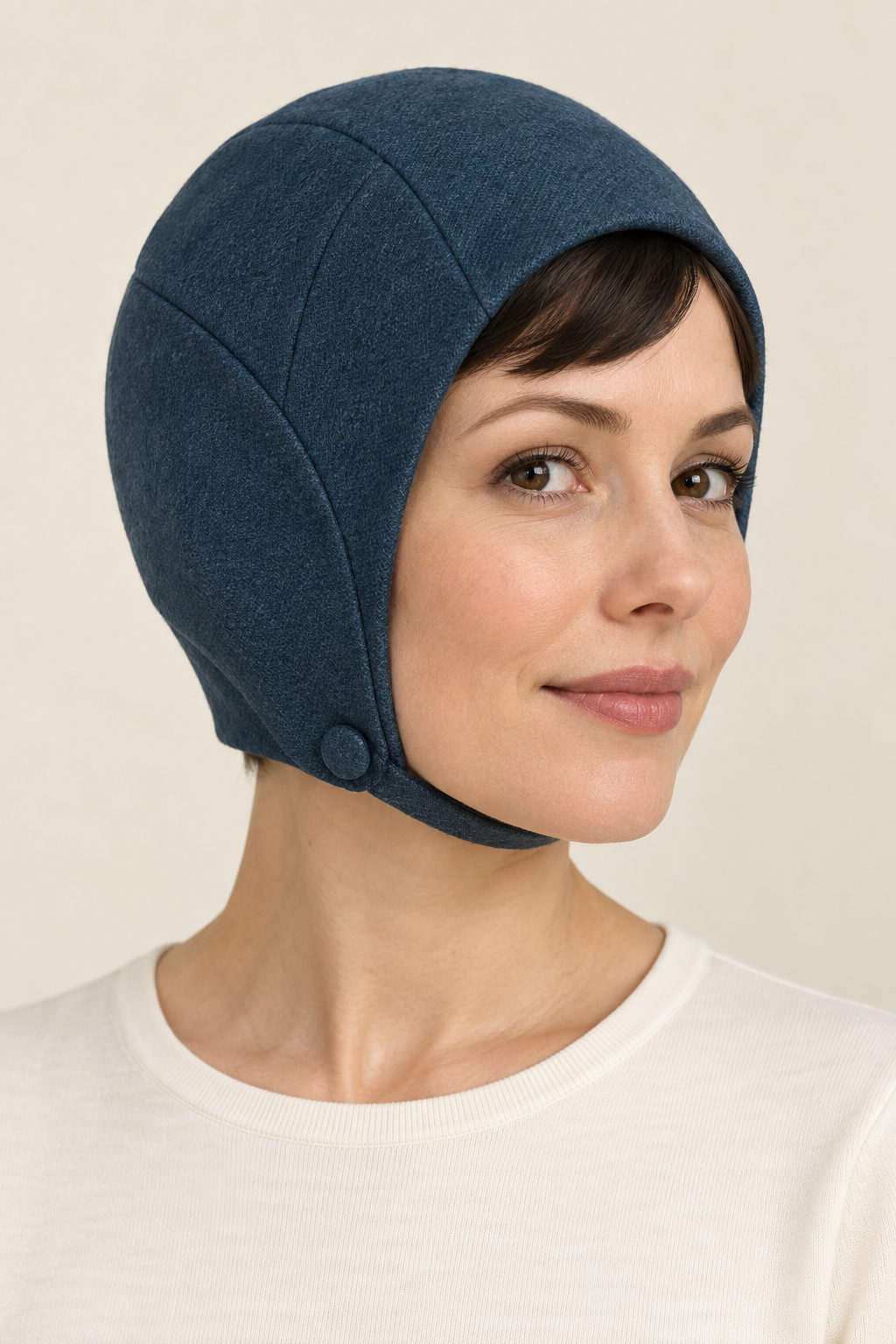 AI design preview: petrol cloth mod hat with a curved face opening, covered ears and a narrow chin strap buttoned at one side