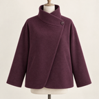 AI design preview: plum asymmetric funnel-neck jacket front with one high side button, diagonal overlap, dropped shoulders and two slanted welt pockets