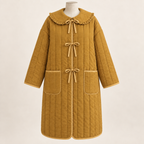 AI design preview: warm honey color of the same tie-front quilted coat with three bows, round ruffled collar and low rounded patch pockets
