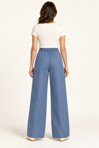 AI design preview: denim-blue wide-leg pants rear with fully gathered elastic waistband, plain back and full-length turned hems