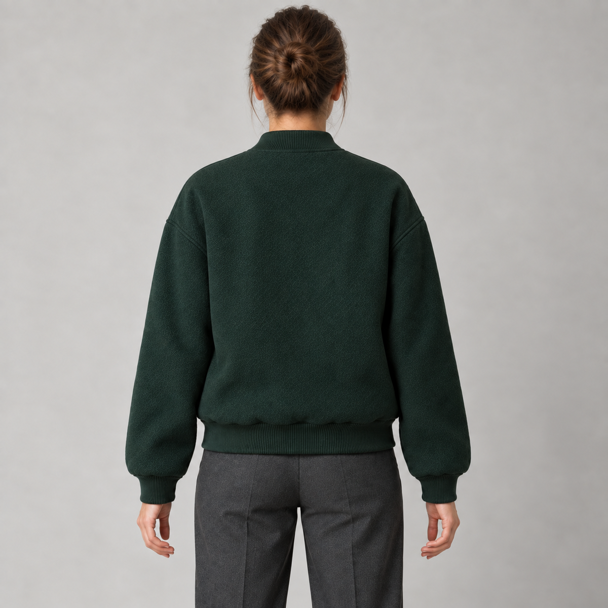 AI design preview: forest-green varsity jacket rear with dropped shoulders, plain back, rib cuffs and rib hem