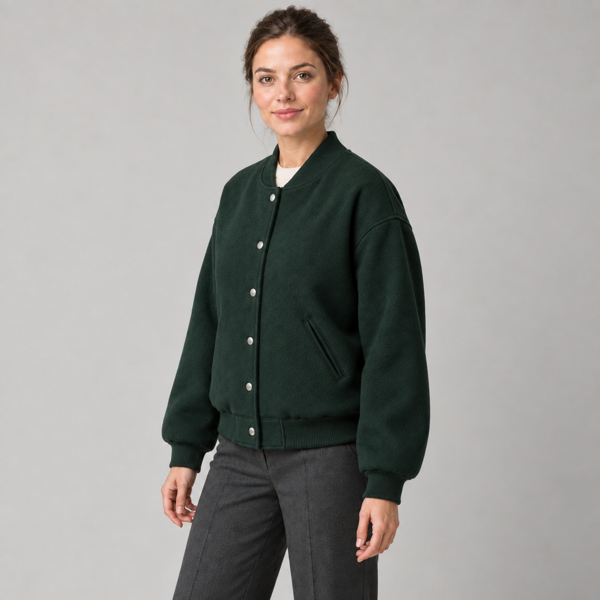 AI design preview: three-quarter front of the same forest-green varsity jacket with six snaps and ribbed edges