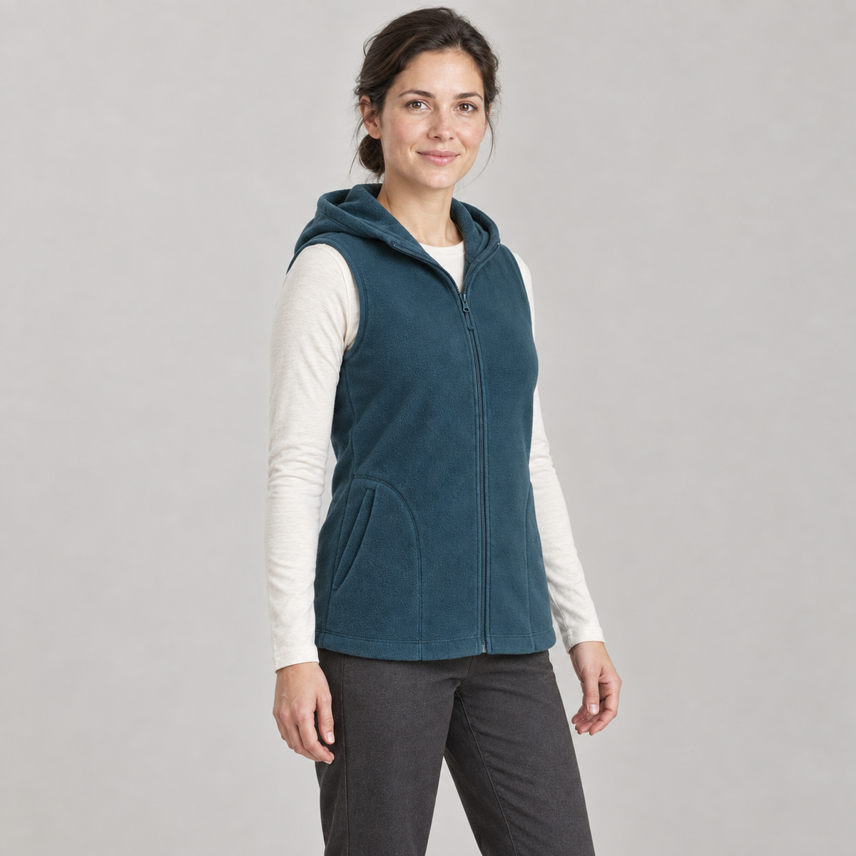 AI design preview: three-quarter front view of the petrol-teal hooded vest, showing the armhole finish and curved pocket entry