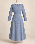 AI back preview of the long-sleeve indigo Hooverette showing its continuous body, scalloped collar and narrow belt