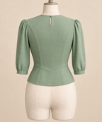 AI back preview of the pale-jade blouse showing three-quarter sleeves, neck opening and shaped lower seam