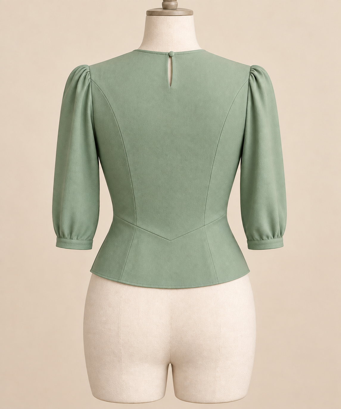 AI back preview of the pale-jade blouse showing three-quarter sleeves, neck opening and shaped lower seam