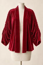 AI design preview: raspberry-red velvet shrug with the same open front and deep gathered sleeves.
