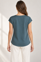 Generated design preview: back view of the slate-teal blouse showing its high neckline, clean back and curved hem.
