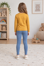 Back view of dusty-blue children's ankle-length leggings styled with an ochre long-sleeve top. Generated design preview.
