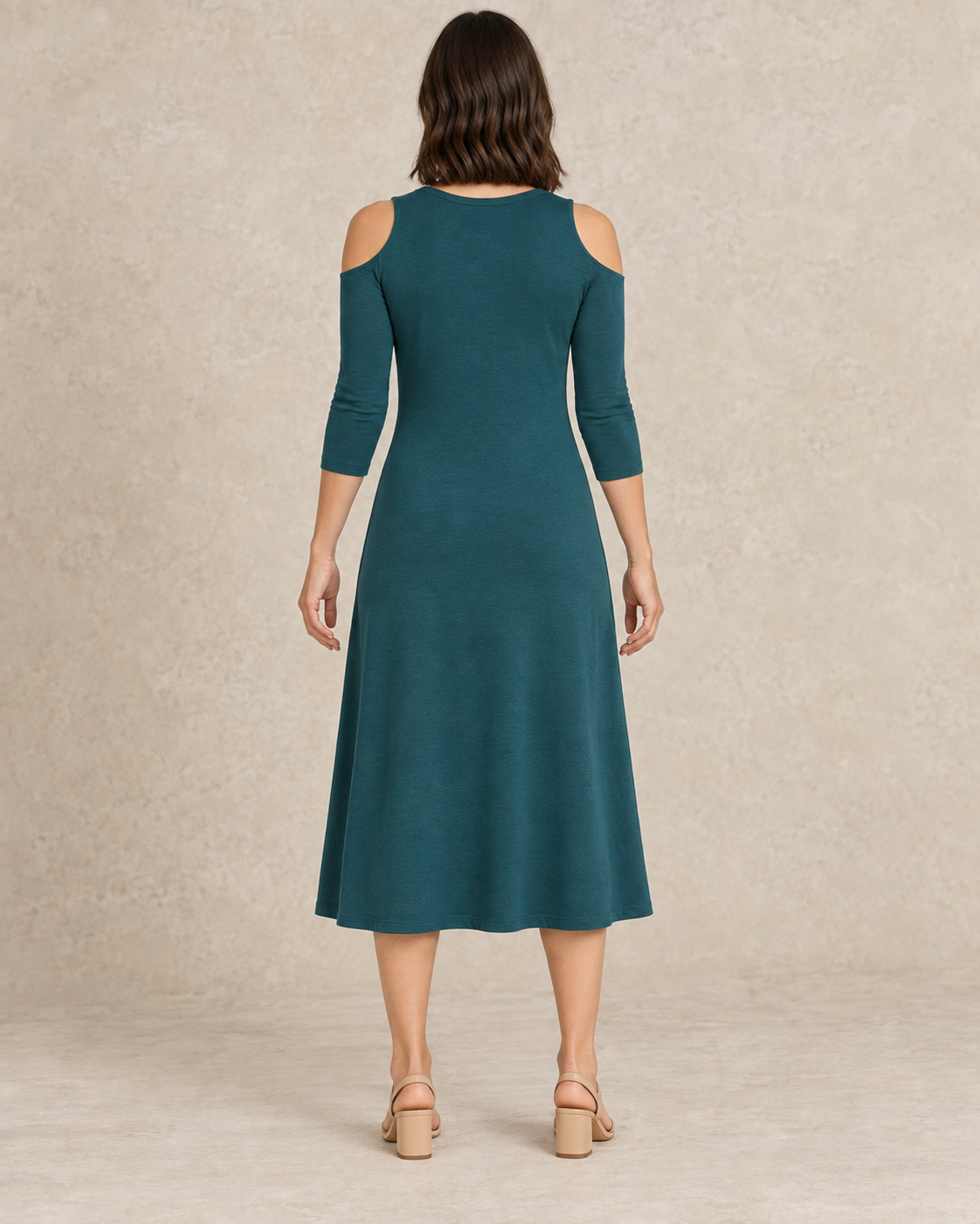 Back view of the teal shoulder-cutout midi dress with a plain back and three-quarter sleeves