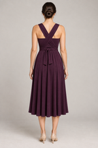 Back design preview of a convertible infinity dress with crossed shoulder panels, a center-back waist tie and matching bandeau.