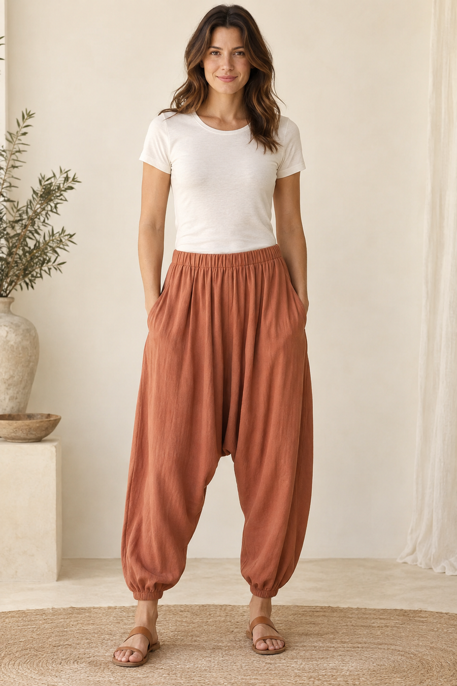 Design preview of dropped-crotch harem pants, front view on an adult model.