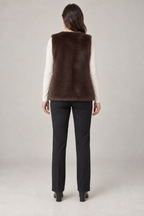 Back view of a cocoa faux fur vest design on a woman