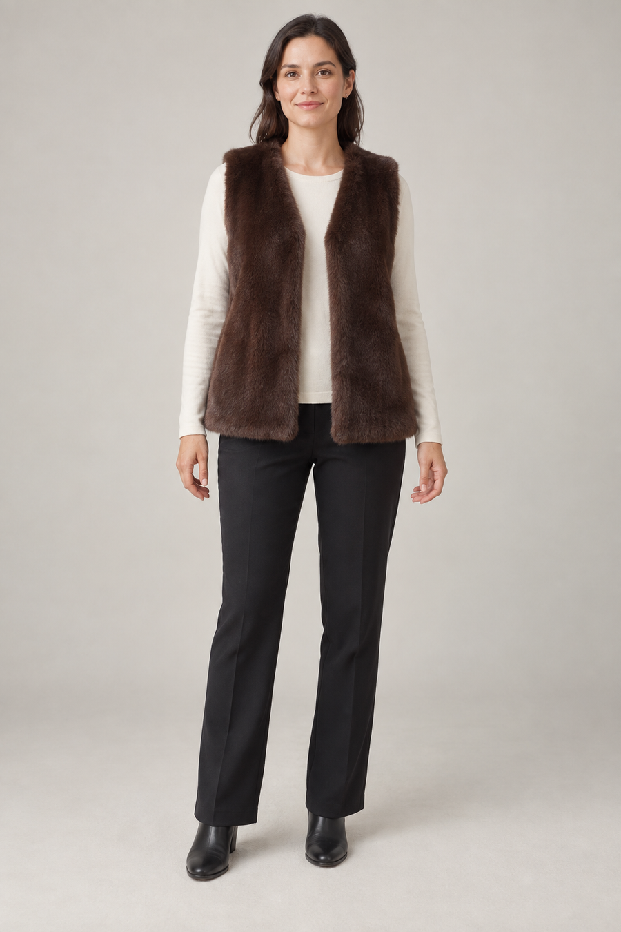 Front view of a cocoa faux fur vest design with an open V front on a woman